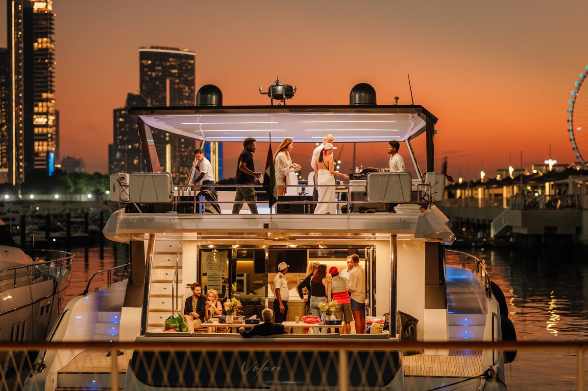 Guests celebrating on a luxury yacht at sunset